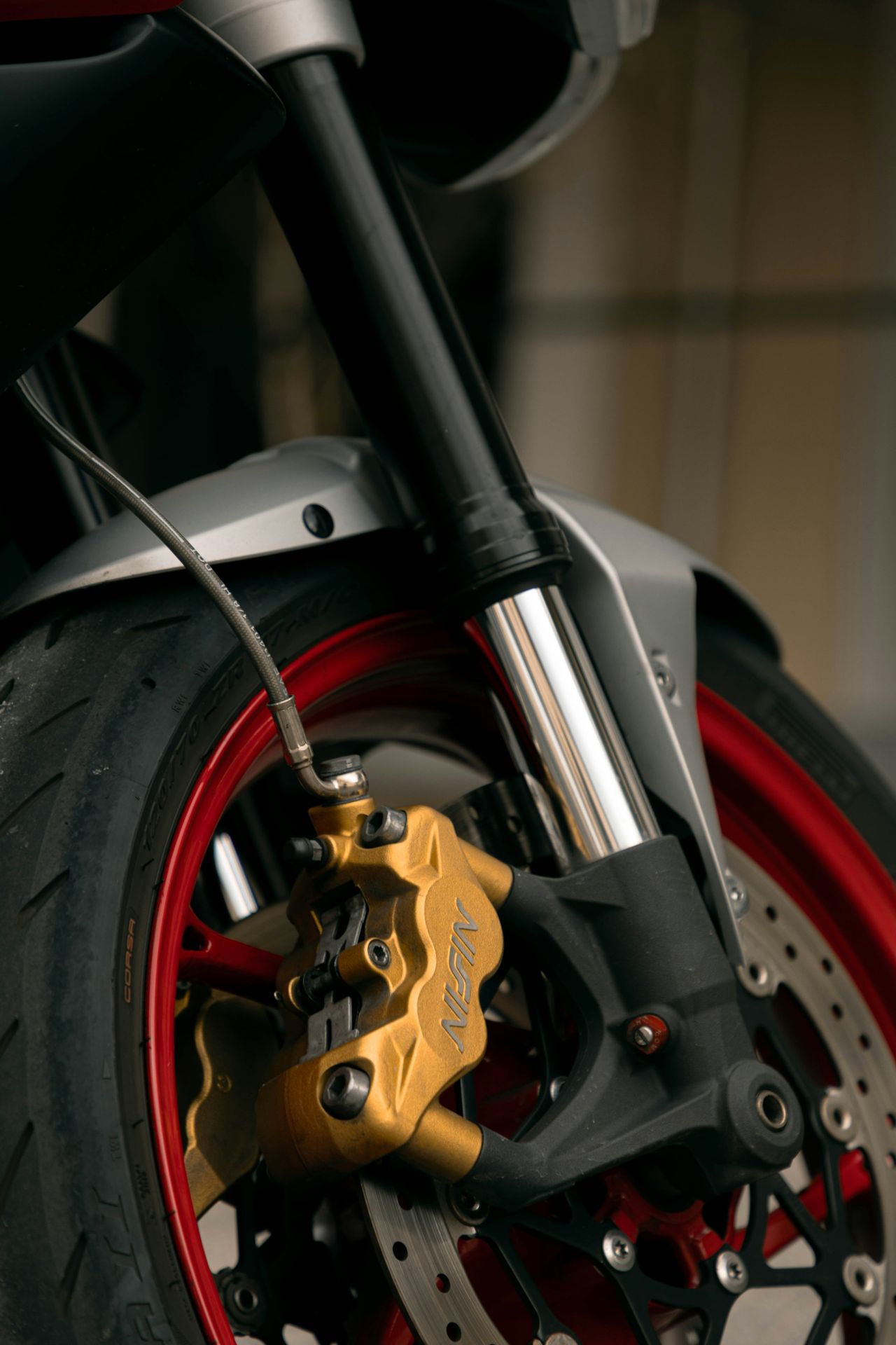 A close up of a motorcycle tire and brake
